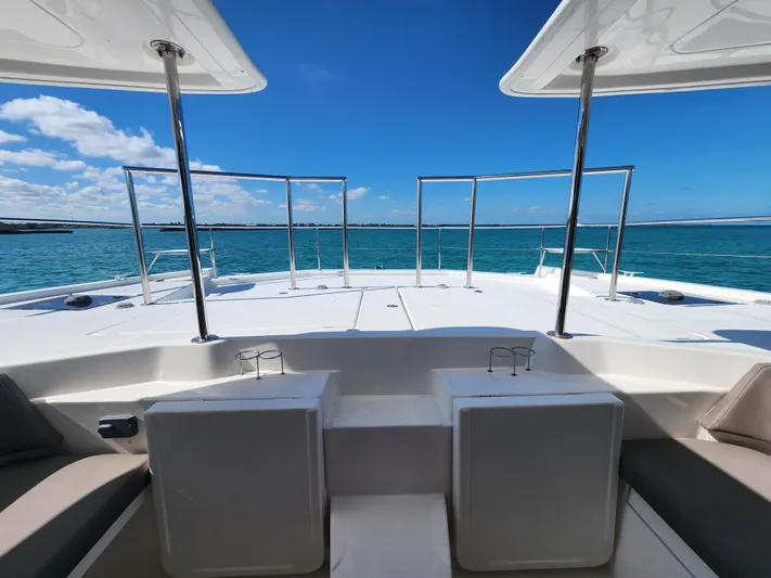 Salty Mitches Yacht Photos Pics 2016 Leopard 51 Powercat deck view with ocean backdrop and clear skies.