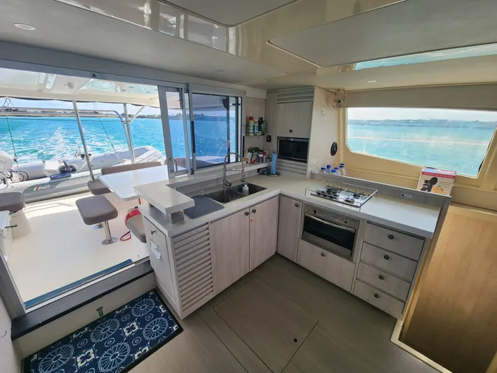 Salty Mitches Yacht Photos Pics Interior of 2016 Leopard 51 Powercat yacht with modern kitchen and ocean view.