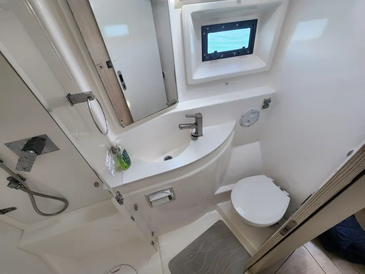 Salty Mitches Yacht Photos Pics Bathroom interior of 2016 Leopard 51 Powercat, featuring modern fixtures and compact design.