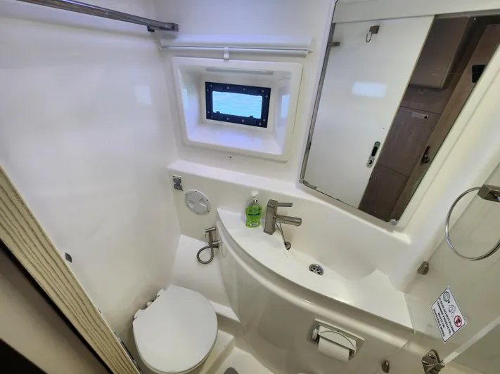 Salty Mitches Yacht Photos Pics Bathroom interior of 2016 Leopard 51 Powercat with sink, toilet, and window.