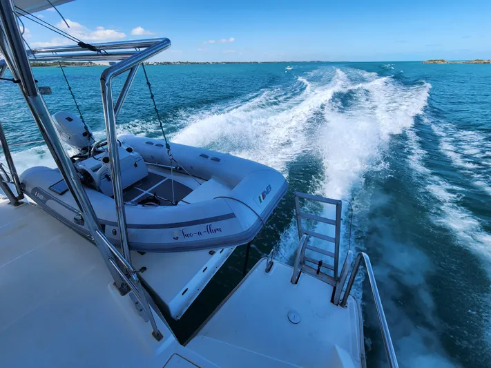 Salty Mitches Yacht Photos Pics Leopard 51 Powercat 2016 cruising with dinghy on turquoise waters.