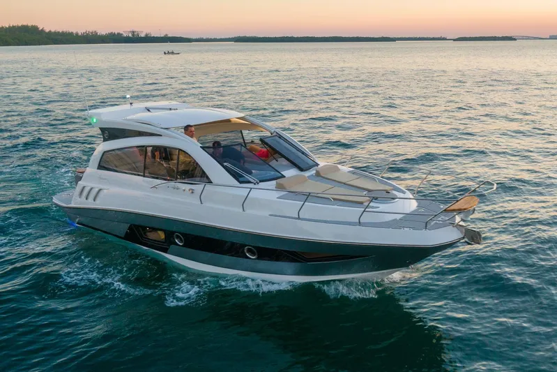  Yacht Photos Pics 2026 Hanover 375 yacht cruising on serene waters at sunset.