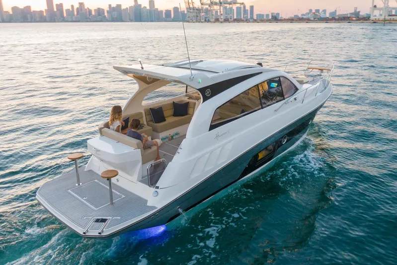  Yacht Photos Pics Luxury Hanover 375 yacht cruising near city skyline at sunset, 2026 model.