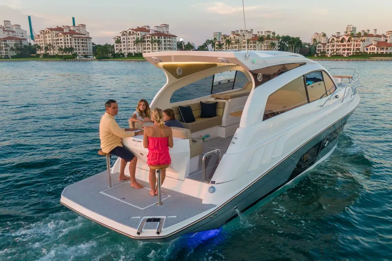  Yacht Photos Pics Luxury Hanover 375 yacht cruising with passengers, 2026 model, near waterfront buildings.