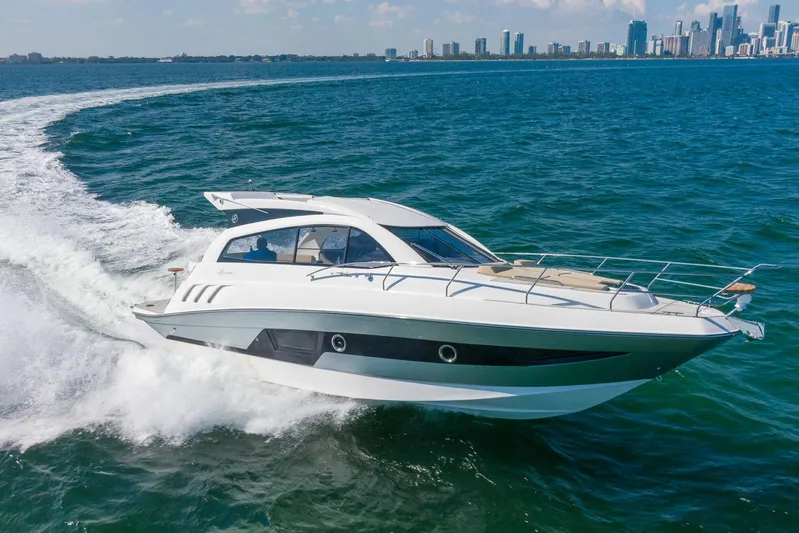  Yacht Photos Pics 2026 Hanover 375 yacht cruising on open water with city skyline in background.