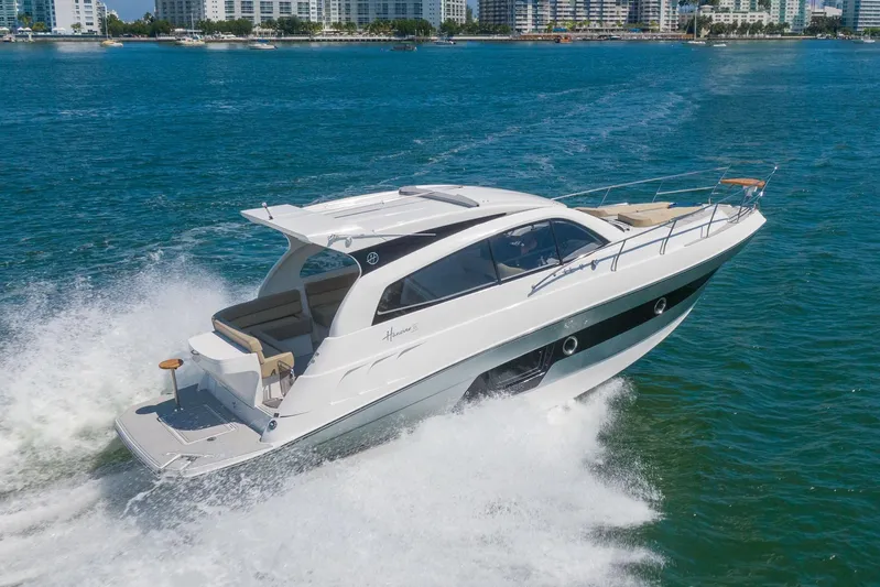  Yacht Photos Pics Luxurious 2026 Hanover 375 yacht cruising on blue waters near city skyline.