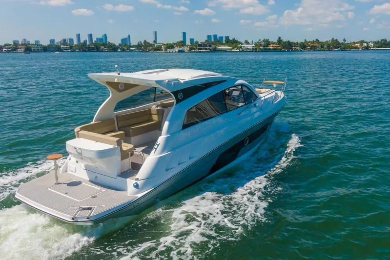  Yacht Photos Pics Luxurious 2026 Hanover 375 yacht cruising on a sunny day with city skyline backdrop.