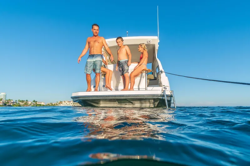  Yacht Photos Pics Family enjoying sunny day on Hanover 375 boat, 2026 model, in clear blue waters.