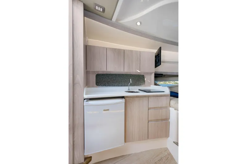  Yacht Photos Pics Modern kitchen in 2026 Hanover 375 yacht with sleek cabinetry and compact appliances.