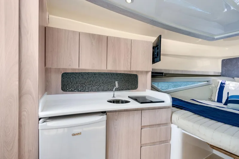  Yacht Photos Pics Modern Hanover 375 yacht interior with kitchenette and cozy sleeping area, 2026 model.
