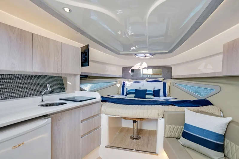  Yacht Photos Pics Luxurious interior of 2026 Hanover 375 yacht with modern kitchen and cozy bed.