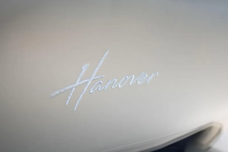  Yacht Photos Pics Hanover 375 2026 logo on beige leather interior, luxury car branding.