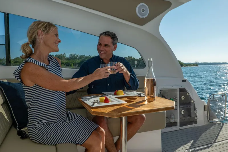  Yacht Photos Pics Couple enjoying a meal on a 2026 Hanover 375 yacht, with scenic ocean views.