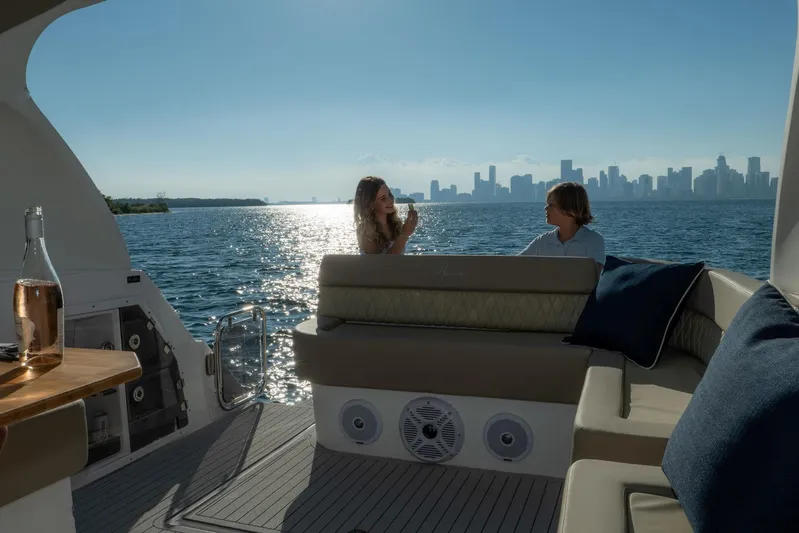  Yacht Photos Pics Couple enjoying a scenic view on a 2026 Hanover 375 yacht, with city skyline backdrop.