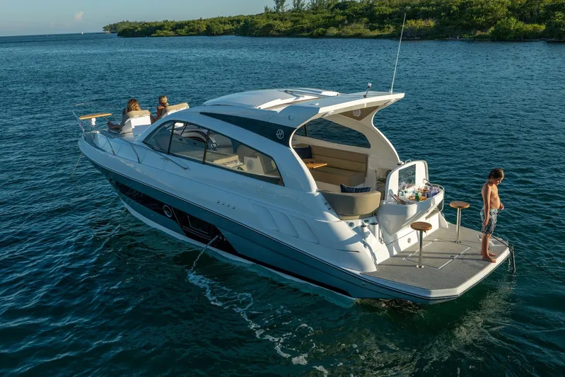  Yacht Photos Pics 2026 Hanover 375 yacht on serene water, featuring passengers enjoying leisure activities.