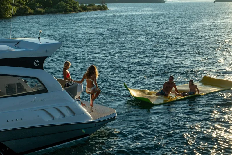  Yacht Photos Pics Luxury Hanover 375 yacht with people enjoying water activities, 2026 model.