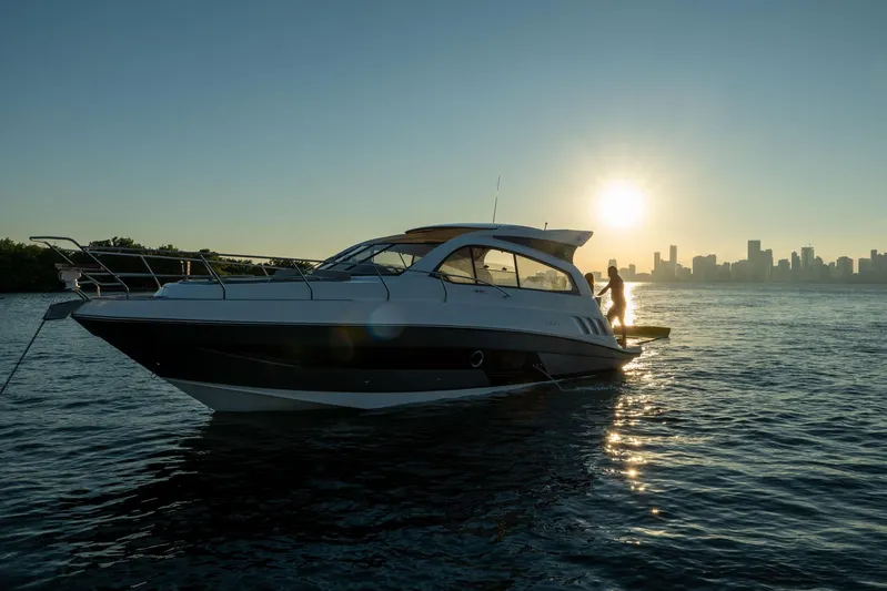  Yacht Photos Pics Luxury Hanover 375 yacht on water at sunset, city skyline in background, 2026 model.