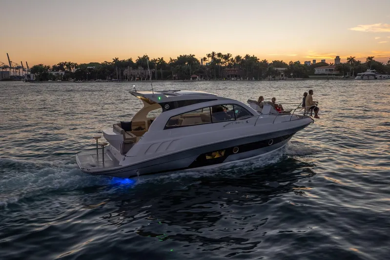  Yacht Photos Pics Luxurious 2026 Hanover 375 yacht cruising at sunset with passengers enjoying the view.