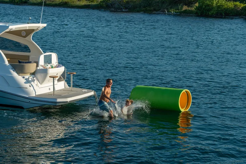  Yacht Photos Pics Man and dog playing near Hanover 375 yacht, 2026 model, on a sunny day.