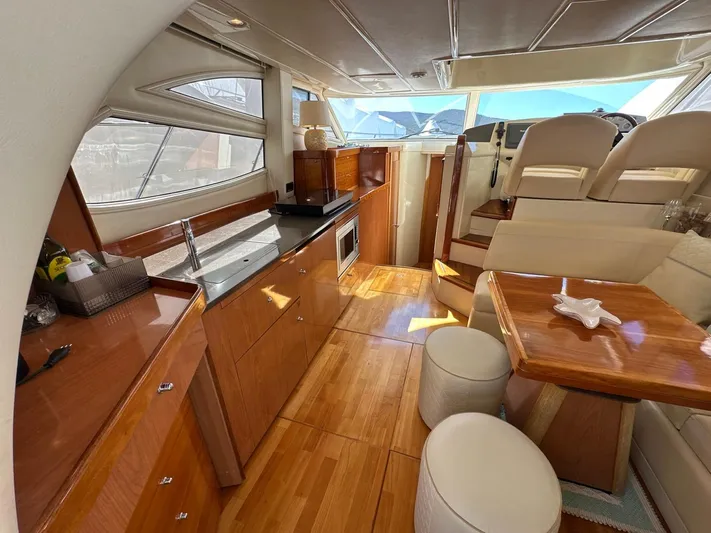Maurizio Nesti Yacht Photos Pics Luxurious interior of 2007 Sealine F42/5 yacht with wood finishes and modern amenities.