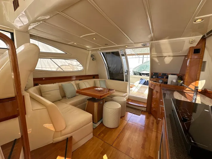 Maurizio Nesti Yacht Photos Pics Luxurious interior of 2007 Sealine F42/5 yacht with elegant seating and wooden finishes.