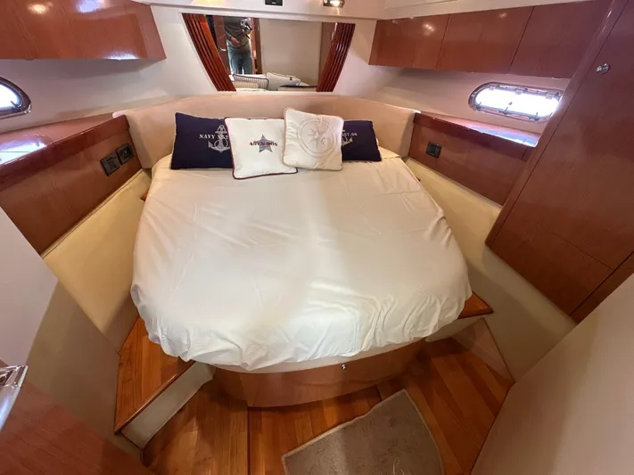 Maurizio Nesti Yacht Photos Pics Luxurious cabin interior of 2007 Sealine F42/5 yacht with cozy bed and wooden accents.