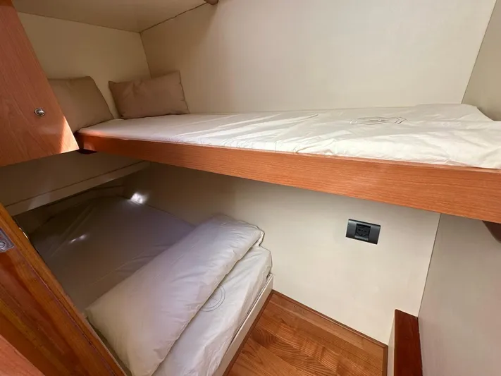 Maurizio Nesti Yacht Photos Pics 2007 Sealine F42/5 yacht cabin with wooden bunk beds and white bedding.