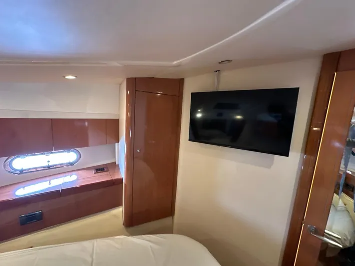 Maurizio Nesti Yacht Photos Pics Interior of 2007 Sealine F42/5 yacht cabin with TV and porthole window.