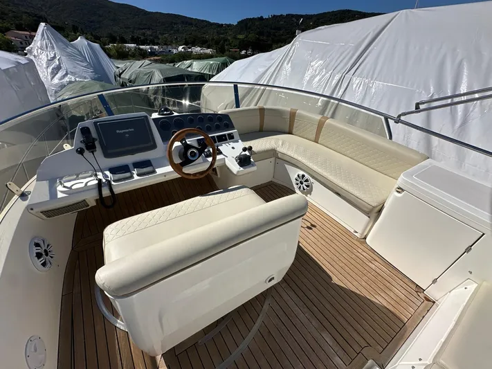 Maurizio Nesti Yacht Photos Pics 2007 Sealine F42/5 yacht cockpit with beige seating and wooden deck.