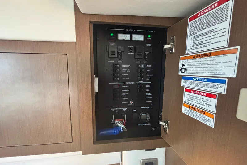 The Braciole Yacht Photos Pics Electrical panel inside 2017 Sea Ray 310 Sundancer boat with safety warnings.