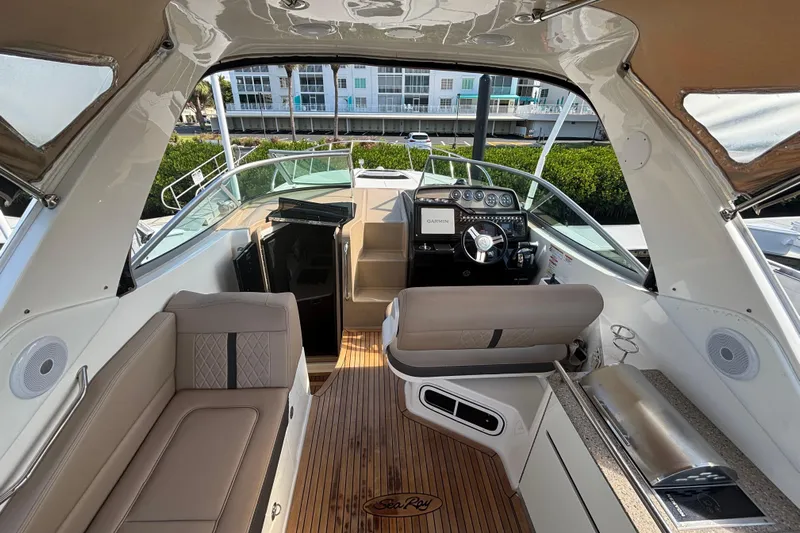 The Braciole Yacht Photos Pics 2017 Sea Ray 310 Sundancer cockpit with modern helm, seating, and wood flooring.