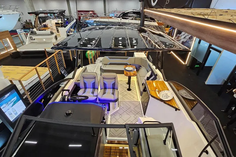  Yacht Photos Pics Luxurious Hanover 327 yacht interior, 2026 model, featuring modern seating and elegant design at a boat show.