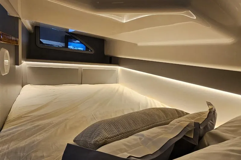  Yacht Photos Pics Luxurious interior of 2026 Hanover 327, featuring a cozy bed and ambient lighting.