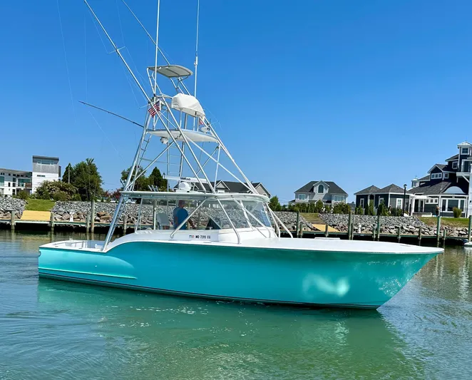 Wire Nut Yacht Photos Pics 2002 Custom Carolina 40 Express Sportfisherman in marina, clear sky, waterfront homes.