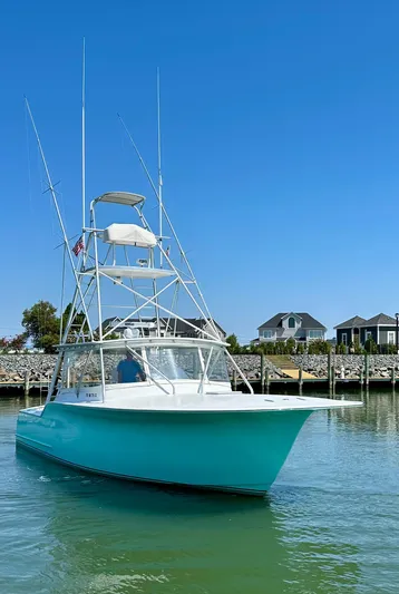 Wire Nut Yacht Photos Pics 2002 Custom Carolina 40 Express Sportfisherman in calm waters, clear sky background.
