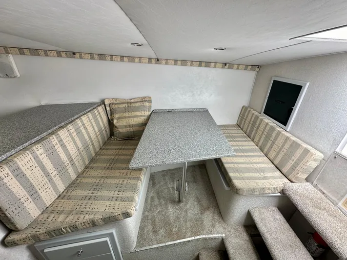 Wire Nut Yacht Photos Pics Interior of 2002 Custom Carolina 40 Express Sportfisherman with striped seating and table.