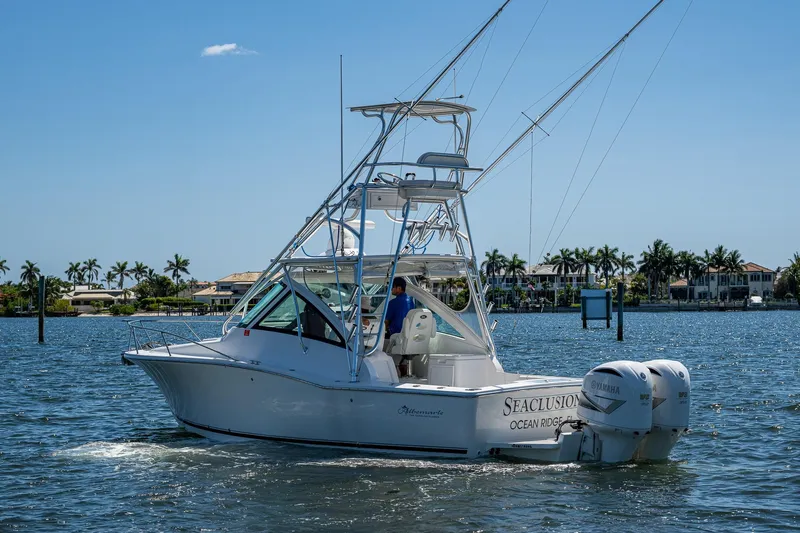 Seaclusion Yacht Photos Pics 2018 Albemarle 290 Express Fisherman boat cruising on a sunny day near palm trees.