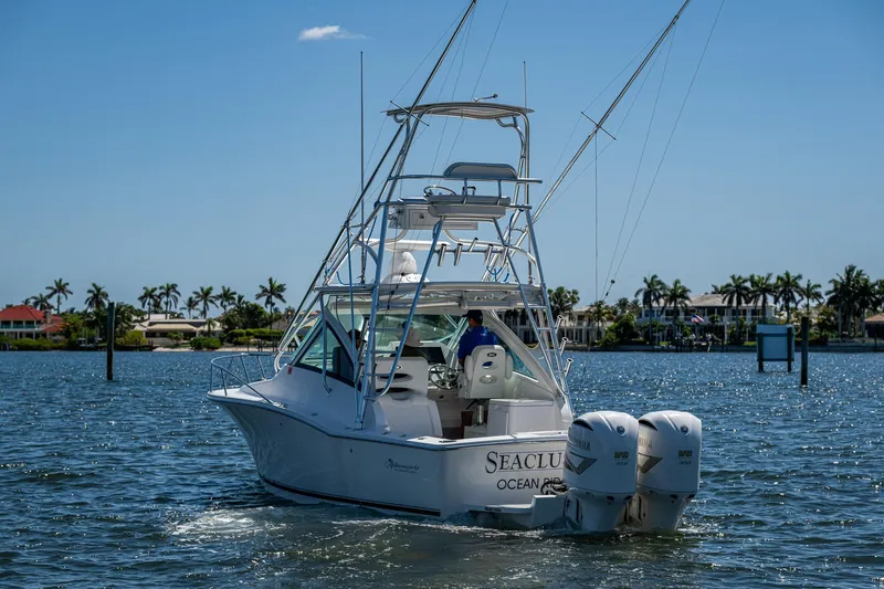 Seaclusion Yacht Photos Pics 2018 Albemarle 290 Express Fisherman boat on water, palm trees in background.