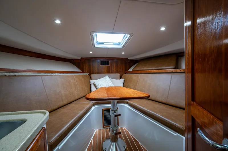 Seaclusion Yacht Photos Pics 2018 Albemarle 290 Express Fisherman cabin with wood accents and cozy seating.