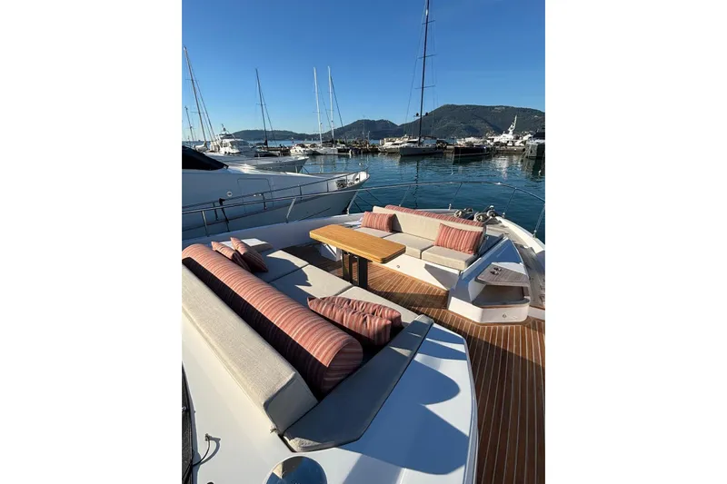  Yacht Photos Pics Luxurious 2025 Ferretti Yachts 720 with elegant outdoor seating in a marina setting.