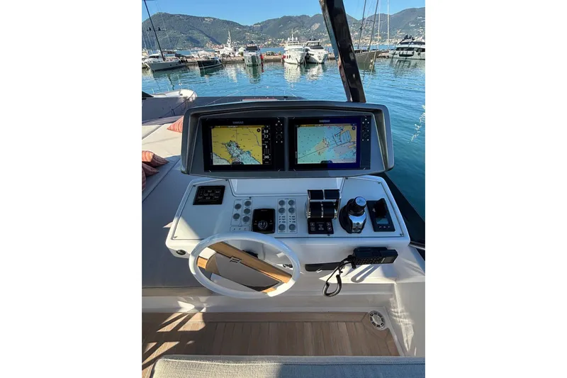  Yacht Photos Pics Helm of 2025 Ferretti Yachts 720 with navigation screens, docked in scenic marina.