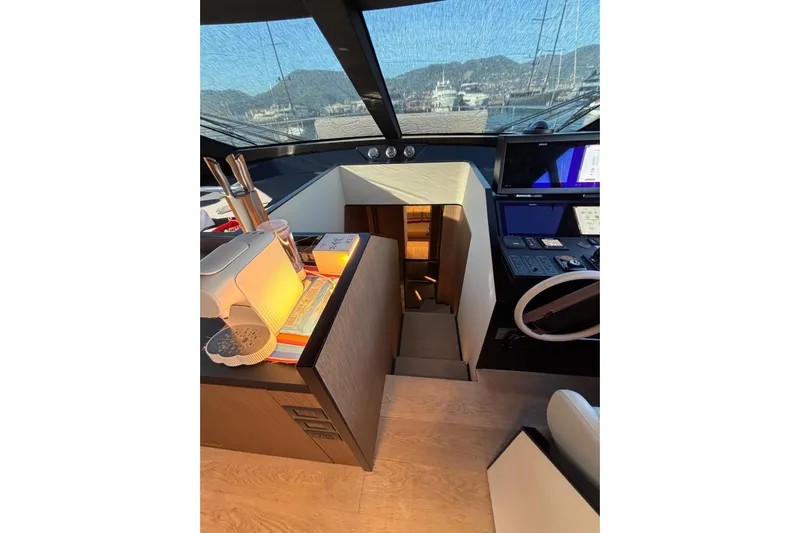  Yacht Photos Pics Interior of 2025 Ferretti Yachts 720, featuring helm station and modern design elements.