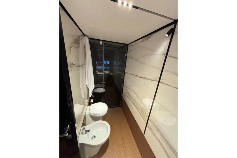  Yacht Photos Pics Luxurious bathroom in 2025 Ferretti Yachts 720, featuring elegant marble walls and modern fixtures.