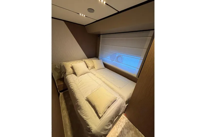 Yacht Photos Pics Luxurious bedroom interior of 2025 Ferretti Yachts 720, featuring elegant bedding and modern design.
