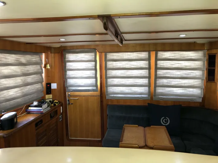 Off The Grid Yacht Photos Pics Interior of 2001 Selene Ocean Trawler with wooden paneling and cozy seating area.