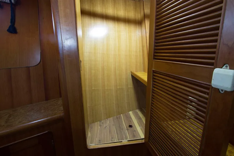 Off The Grid Yacht Photos Pics Wooden interior of 2001 Selene Ocean Trawler, featuring a closet with louvered door.