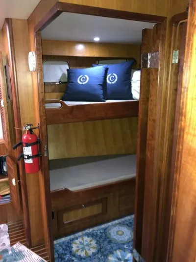 Off The Grid Yacht Photos Pics 2001 Selene Ocean Trawler cabin with wooden bunk beds and nautical-themed pillows.