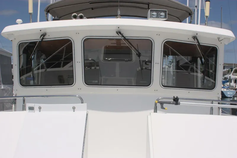 Off The Grid Yacht Photos Pics 2001 Selene Ocean Trawler front view with large windows and clean white exterior.