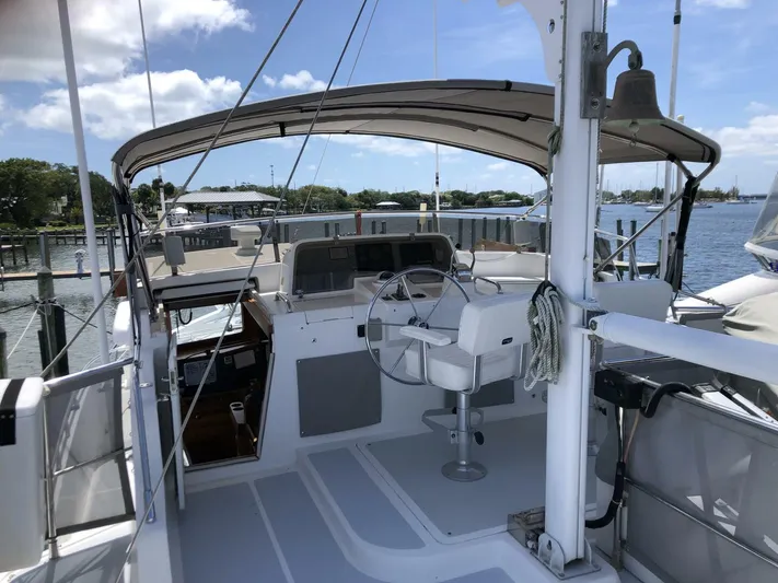 Off The Grid Yacht Photos Pics 2001 Selene Ocean Trawler helm with canopy, docked at marina under clear skies.