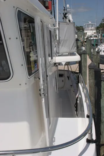 Off The Grid Yacht Photos Pics 2001 Selene Ocean Trawler docked, side view showing deck and railing.